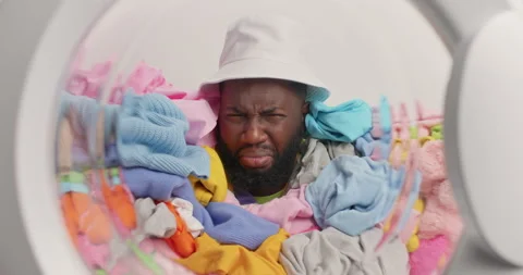 Dissatisfied dark skinned Afro American man fed up of everyday domestic chores Stock Footage 156632918