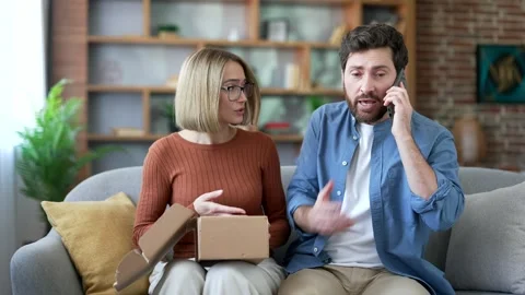 Dissatisfied married couple received a parcel with the wrong product while Stock Footage 323819356