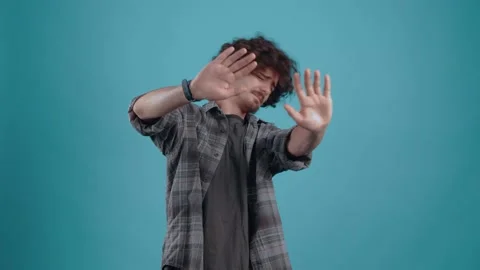 Dissatisfied young man with his hands in front shows the gesture of refusal. Stock Footage 149758134