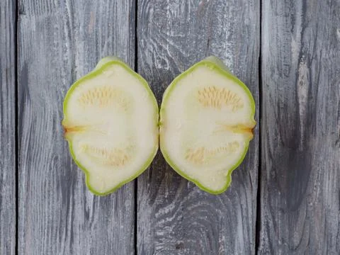 Dissected pattypan squash on old rustic wooden background. Stock Photos
