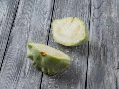 Dissected pattypan squash on old rustic wooden background. Stock Photos