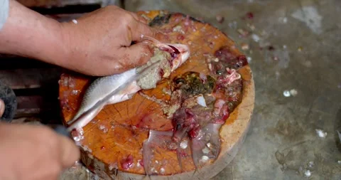 Dissection of fish belly with a knife to remove any inedible material. Stock Footage 247790467
