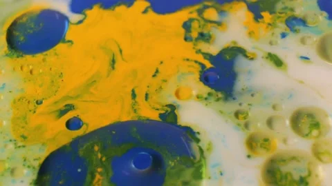 Dissolution and movement of green and yellow flowers in milk. Video stock 171374047