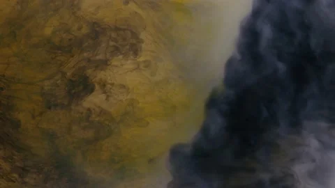Dissolution of threads of black paint in white-yellow shining smoke, on a black Stock Footage 171084316