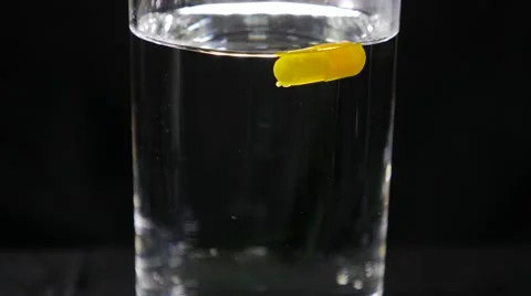 Dissolve capsule in water part 1of2 Stock Footage 49322665