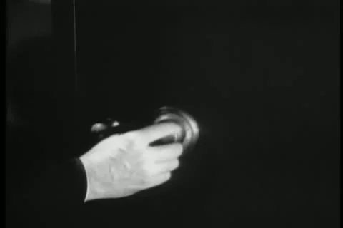 Dissolve from hand opening safe to doorknob turning Stock Footage 25208324