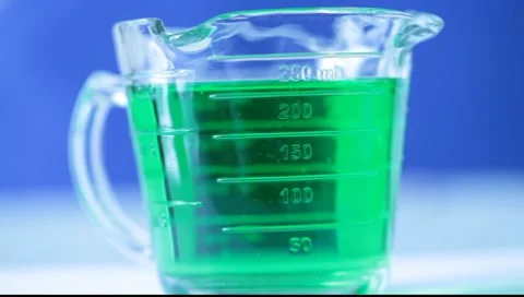 Dissolving in Green Fluid Stock Footage 7727392
