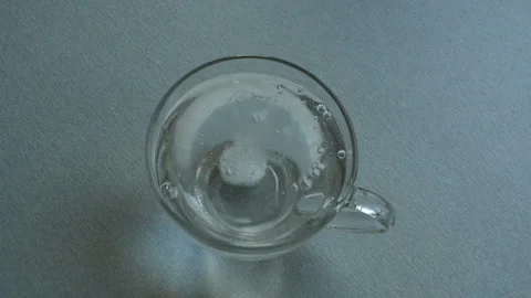 Dissolving pill effervescent  in a glass Stock Footage 147988688