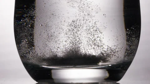 Dissolving tablet dropped into a glass of water Video stock 57483534