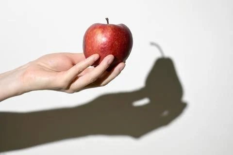 Dissonance Concept. Apple Fruit and Pear Fruit Shadow Stock Photos