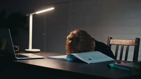Distance learning, a boy sits at a table at home looking in a beech laptop. The Stock Footage 165306928