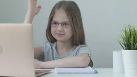 Distance learning concept. Primary school girl in glasses studying online using Stock Footage 194569606