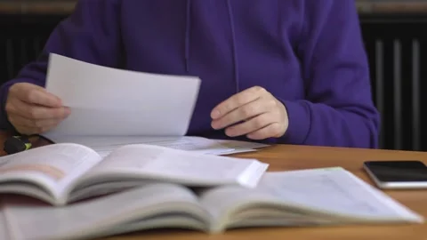 Distance learning concept self-education student purple sweatshirt sitting table Stock Footage 246714384