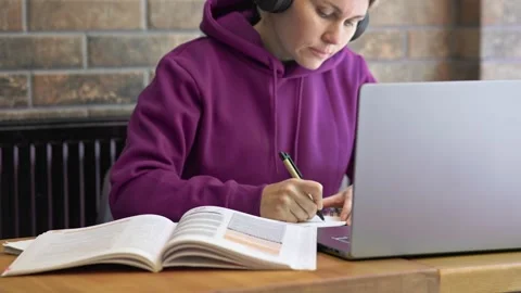 Distance learning concept self-education student purple sweatshirt sitting table Video stock 246714648