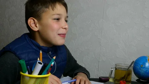 Distance learning. Funny schoolboy gets online education. Stock Footage 127975715