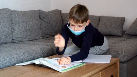 Distance learning at home. Isolated child Quarantined at Home in mask Stock Footage 126994522