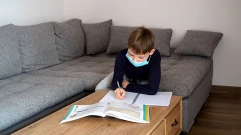 Distance learning at home. Isolated child Quarantined at home in mask Stock Footage 126994651