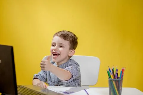 Distance learning online education. A boy siting at home and does school home Stock Photos