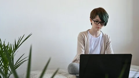 Distance learning online education. Teen schoolgirl studying home using laptop Stock Footage