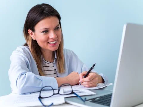 Distance learning online education. Woman studying with laptop, watching webinar Stock Photos