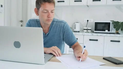 Distance learning, online lesson. Focused smart adult male student studying Stock-Footage 260843272