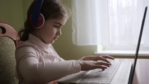 Distance Learning. Schoolgirl Studying Online Using Laptop. School Student Stock Footage 213907963