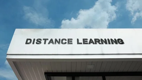 Distance learning word sign displayed on building with blue sky background Stock Footage 318625938