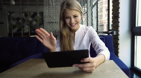 Distance is not a problem. Beautiful cheerful young blonde woman holding her Stock Footage 67648434