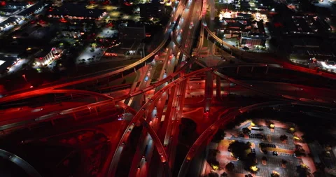 Distancing from the complex road intersection colored red with street lights. Stock Footage 323009724