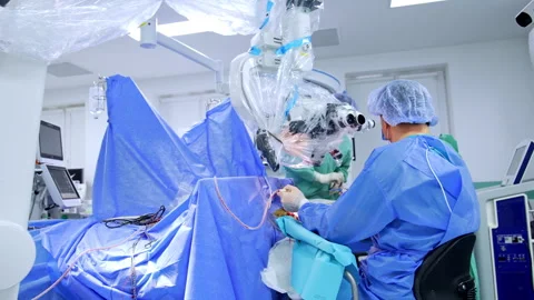 Distancing from a doctor sitting at microscope. Stock Footage 307941164