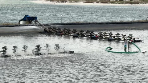 Distant aerator turns, sending smooth surface motion across the whole pond under Stock-Footage 323981036
