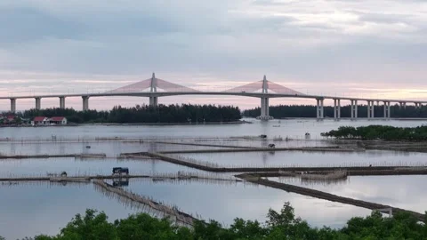 Distant aerial of Thuan An Bridge at dusk 4K Stock Footage 339860921