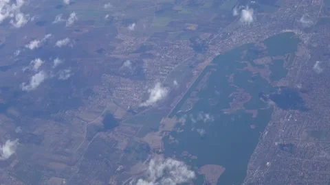 Distant aerial view of a flat land with a lake Video stock 141560728