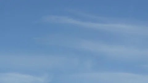 Distant Airplane Trail with Clouds and Blue Sky Stock Footage 73801244