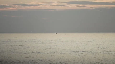 The distant appearance of a ship sailing in the middle of the ocean Stock Footage 255998310