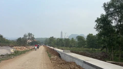 Distant Bao Thien Tower Viewed From Rural Road at Bai Dinh Complex in Vietnam Stock Footage 336253595
