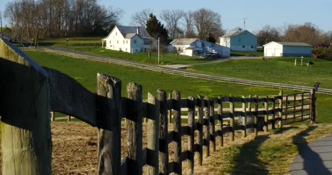 Distant barn bathed in the warm light of sunset. A perfect example of beauty in  Video stock 237692410