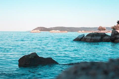 Distant blue adriatic sea with a tiny ferry ship far, outlines of islands mee Stock Photos