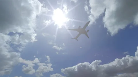 Distant Boing 787 flying across beautiful cloudy sky. 4K sunny weather pan video Stock Footage 60699171
