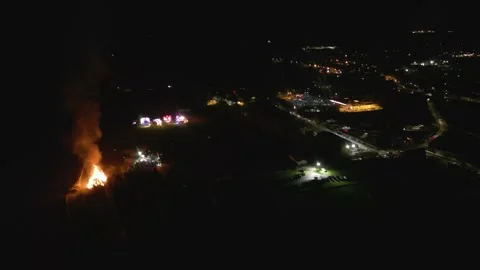 Distant bonfire's smoke flames local fair tain scotland scene crowd gathered to 動画素材 292022149