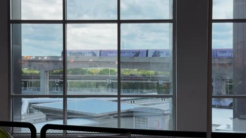 Distant BTS Skytrain Passing Through Bangkok Urban Landscape Stock Footage 345513547