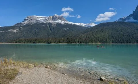 Distant Canoe on Emerald Lake Stock Photos