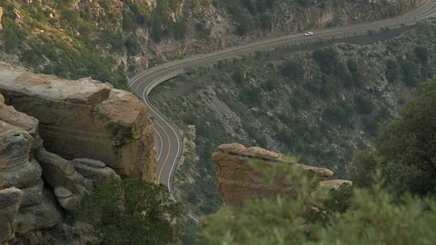 A distant car on a curvy mountain road Stock Footage 112651745
