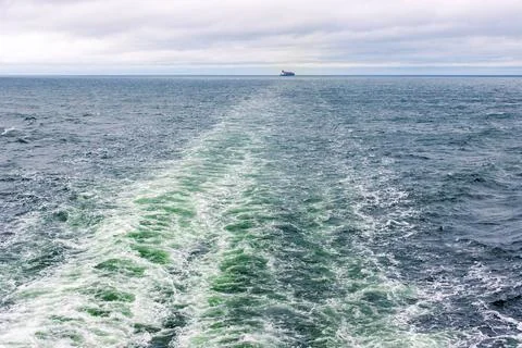 Distant cargo ship sailing across the Baltic Sea between Helsinki, Finland,.. Stock Photos