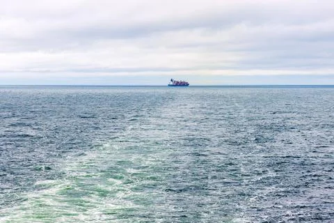 Distant cargo ship sailing across the Baltic Sea between Helsinki, Finland,.. Stock Photos