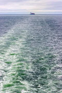 Distant cargo ship sailing across the Baltic Sea between Helsinki, Finland,.. Stock Photos