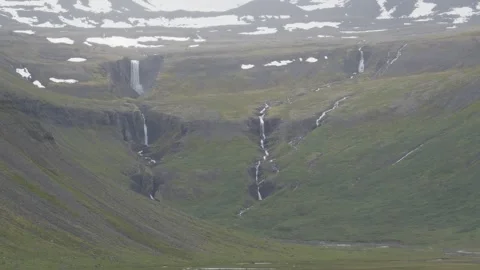 Distant Cascading Waterfalls on a Rugged Mountain Landscape in Iceland Stock Footage 339772810