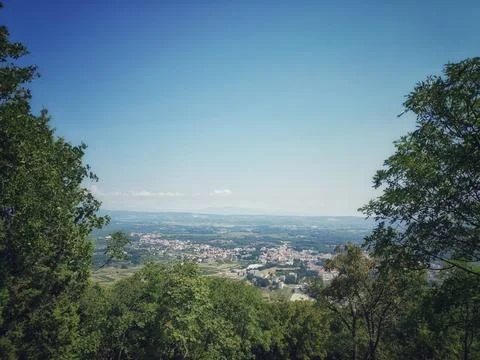 Distant City View Framed by Forest and Wilderness Under a Blue Sky Stock Photos