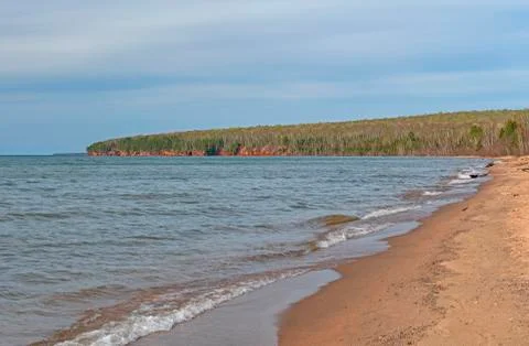 Distant Cliffs on a Quiet Beach Photos