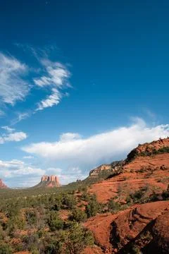 Distant clouds enliven scene of red rocks and mesas in Sedona, Arizona Stock Photos